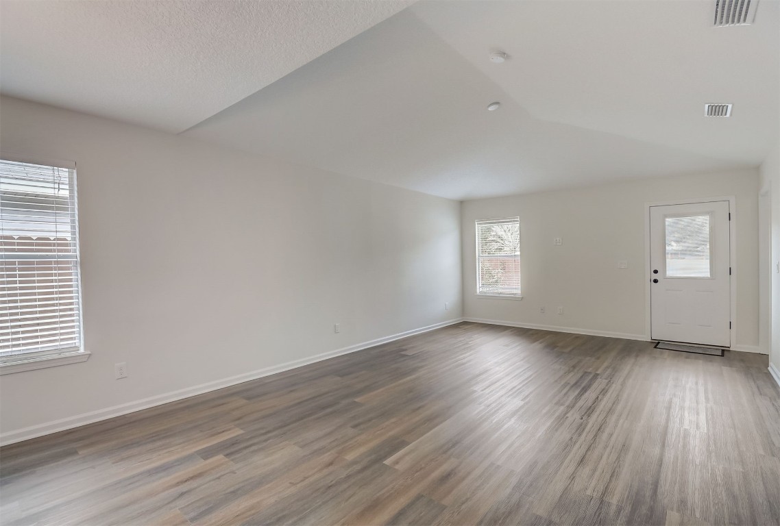 96099 Starlight Lane Yulee, FL 32097 - Photo 5 of 36 an empty room with wooden floor and window