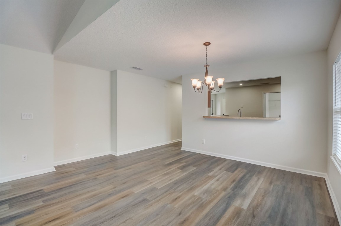 96099 Starlight Lane Yulee, FL 32097 - Photo 7 of 36 a view of a room with wooden floor chandelier and a window