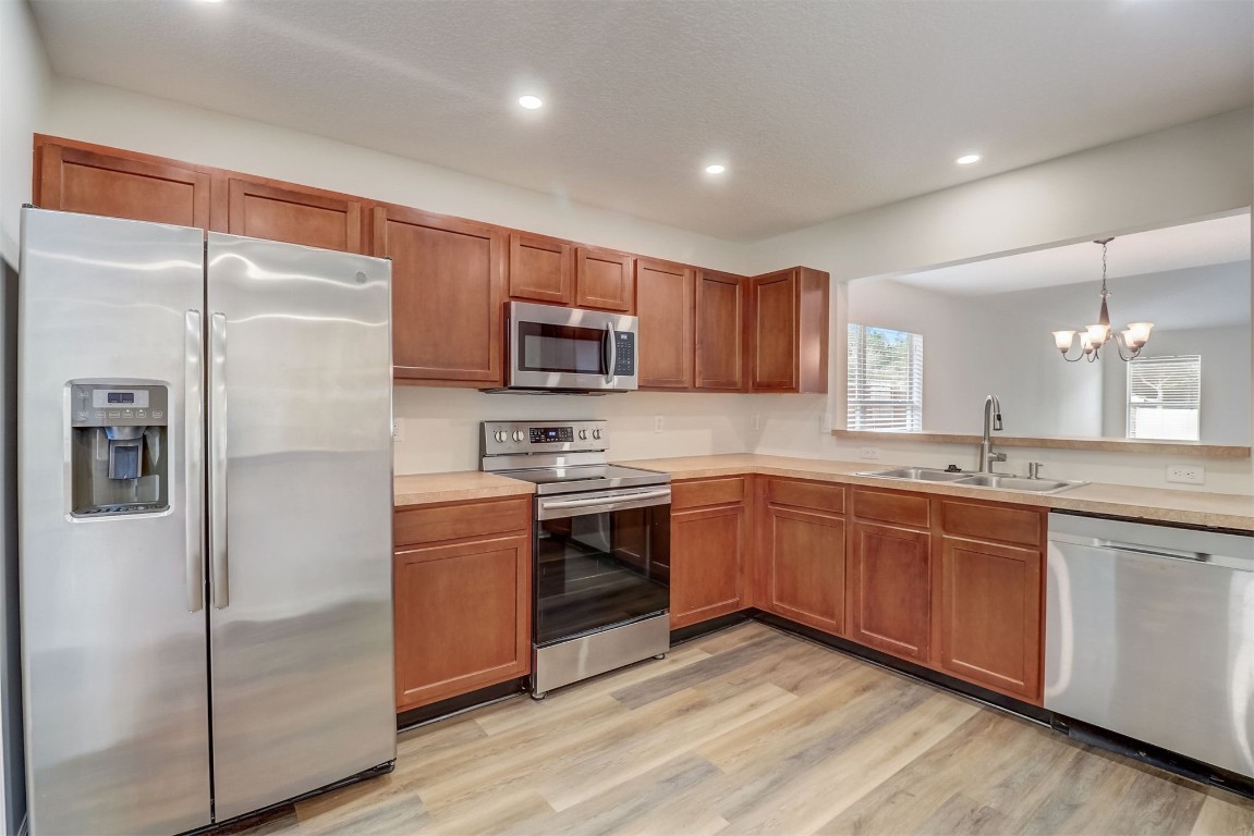 96099 Starlight Lane Yulee, FL 32097 - Photo 10 of 36 a kitchen with stainless steel appliances granite countertop a refrigerator a stove a sink and a microwave