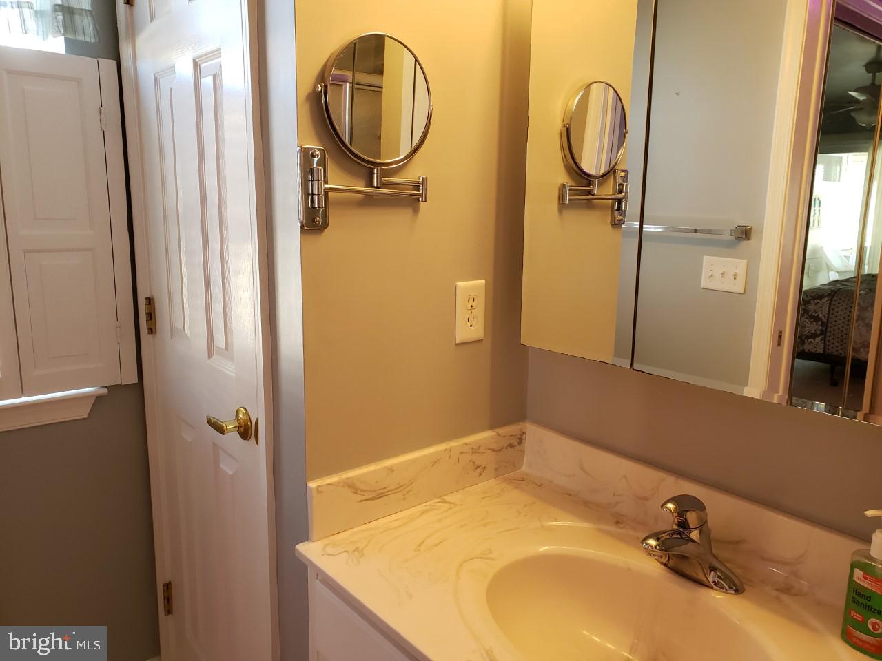 13 Pecan Court, Unit 67G Lewes, DE 19958 - Photo 11 of 25 a bathroom with a sink and a mirror