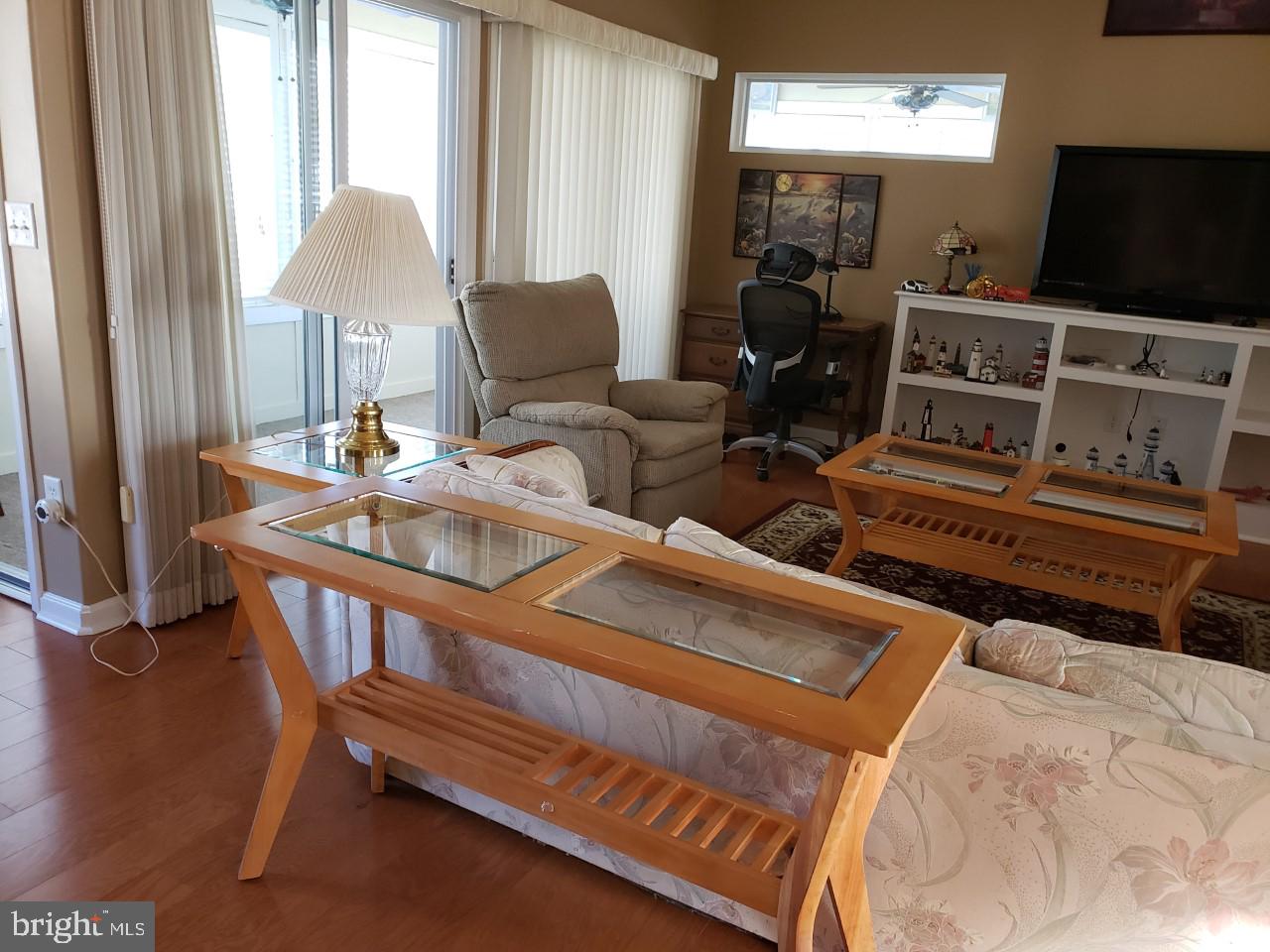 13 Pecan Court, Unit 67G Lewes, DE 19958 - Photo 15 of 25 a bedroom with furniture and a flat screen tv