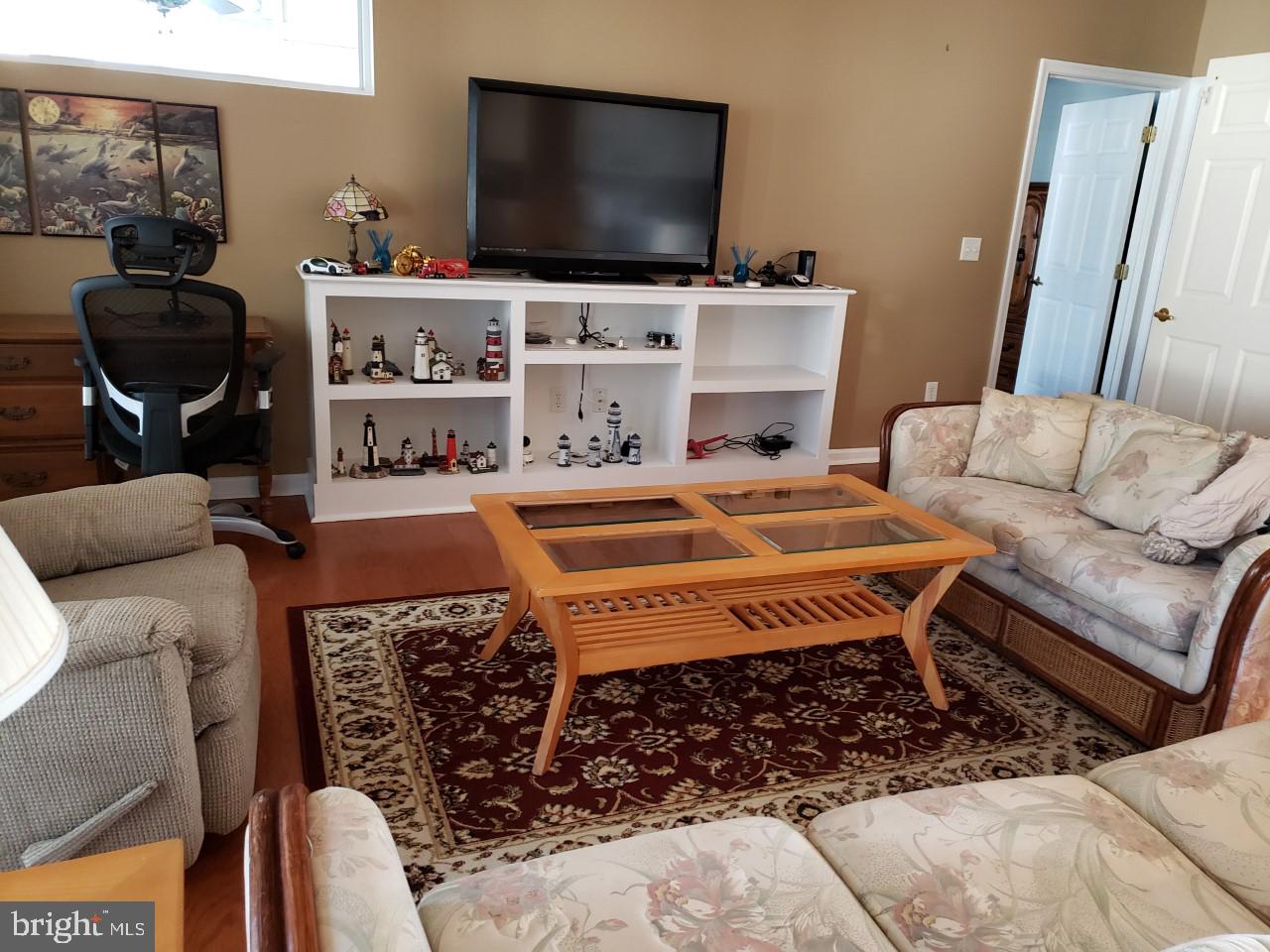 13 Pecan Court, Unit 67G Lewes, DE 19958 - Photo 16 of 25 a living room with furniture and a flat screen tv
