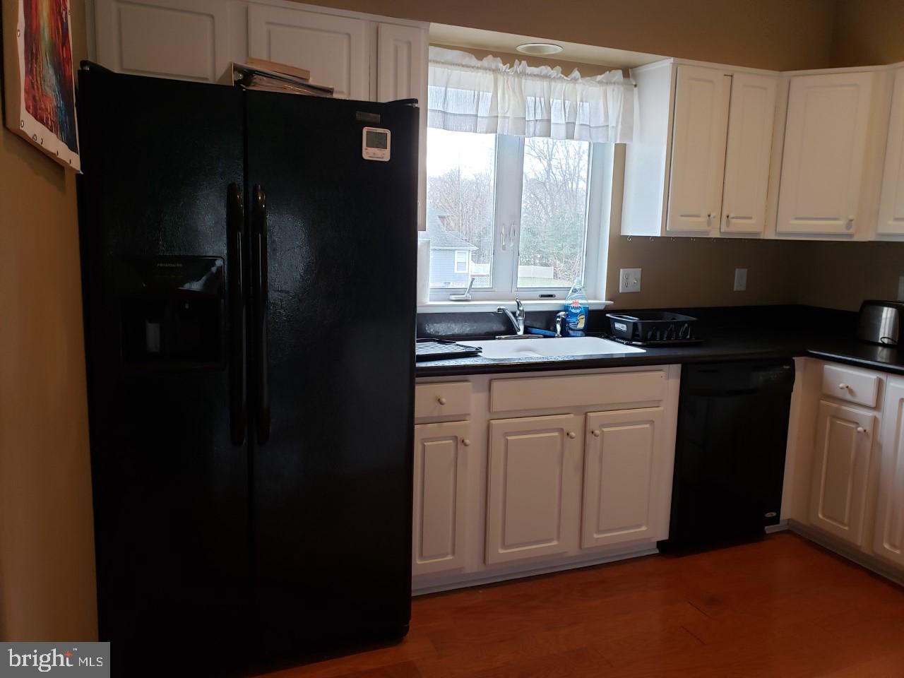 13 Pecan Court, Unit 67G Lewes, DE 19958 - Photo 22 of 25 a kitchen with a sink a window and cabinets