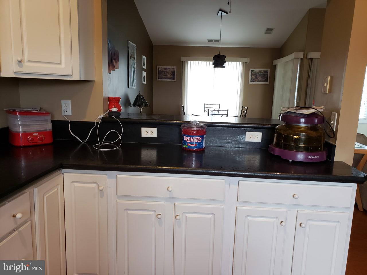 13 Pecan Court, Unit 67G Lewes, DE 19958 - Photo 23 of 25 a kitchen with white cabinets and window