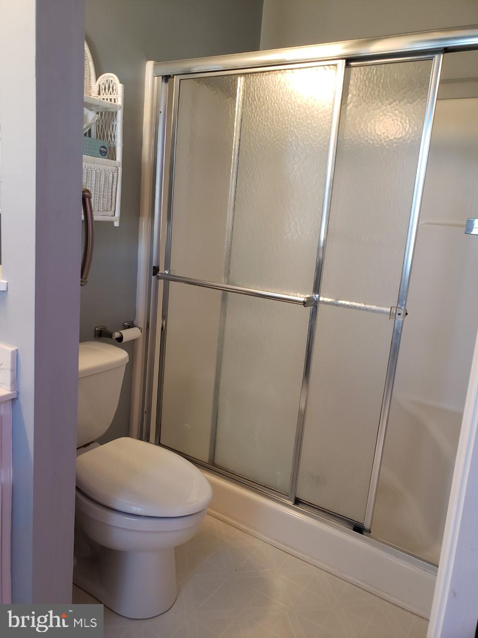 13 Pecan Court, Unit 67G Lewes, DE 19958 - Photo 10 of 25 a white toilet sitting next to a shower