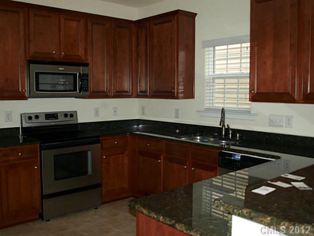 9942 Caldwell Depot Road Cornelius, NC 28031 - Photo 2 of 9 a kitchen with a sink a stove and cabinets