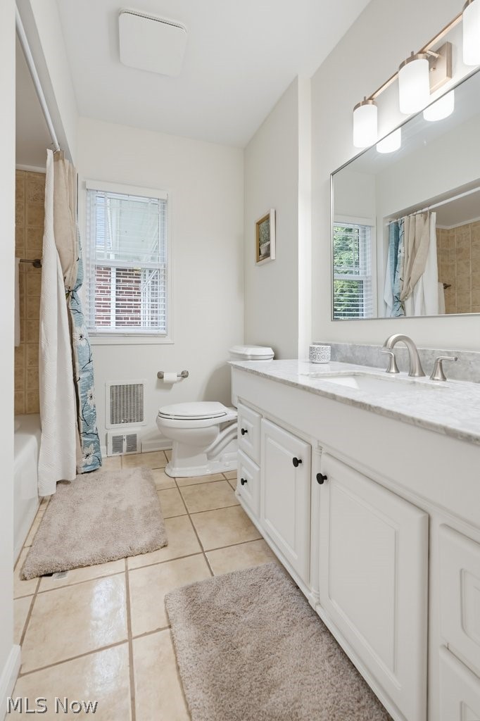 2468 Ridgewood Road Akron, OH 44313 - Photo 33 of 50 White vanity with cabinet storage, marble-finish countertop, brushed nickel faucet, and tile flooring