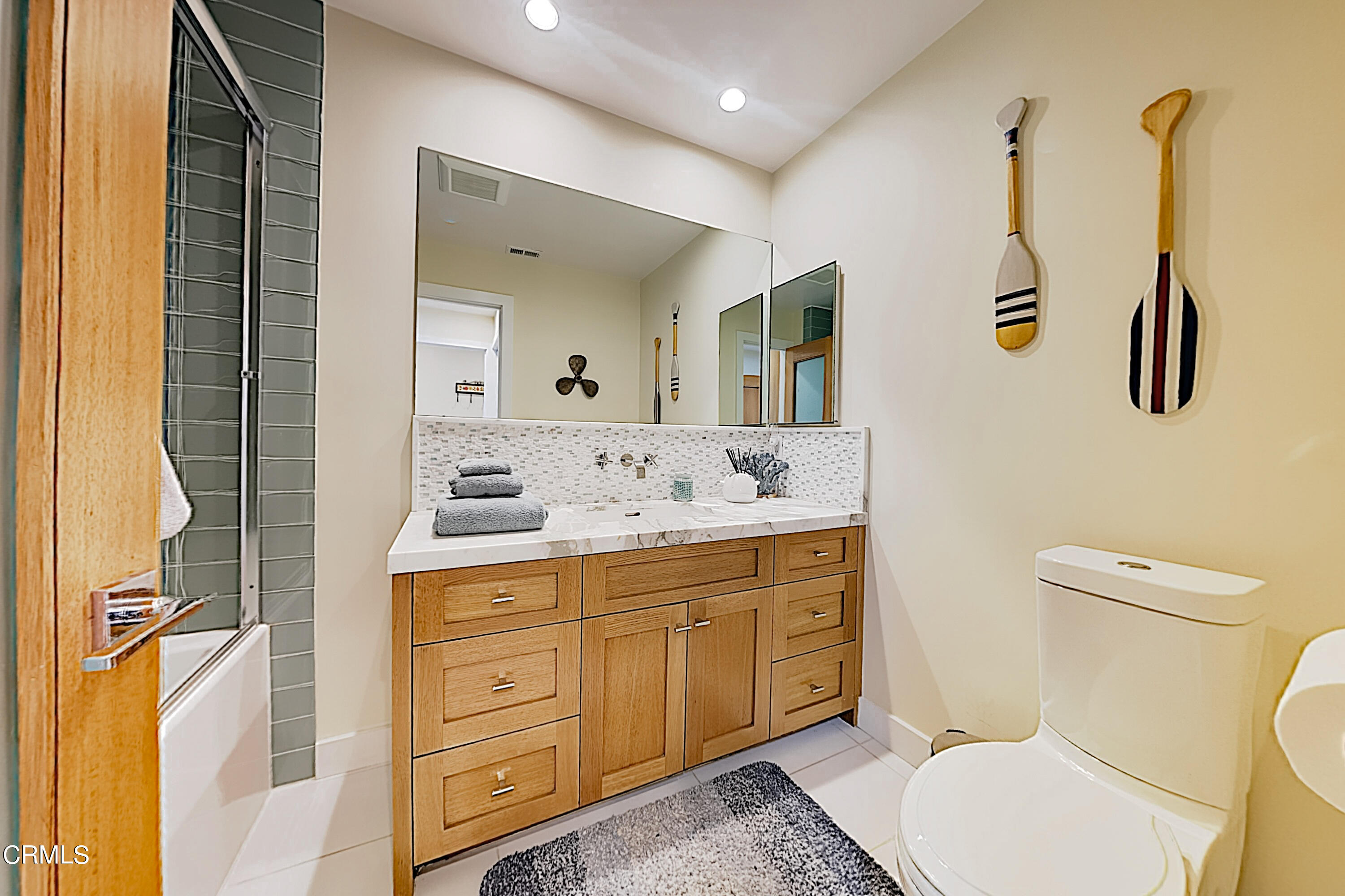 4531 Costa De Oro Oxnard, CA 93035 - Photo 14 of 26 a bathroom with a toilet sink and mirror