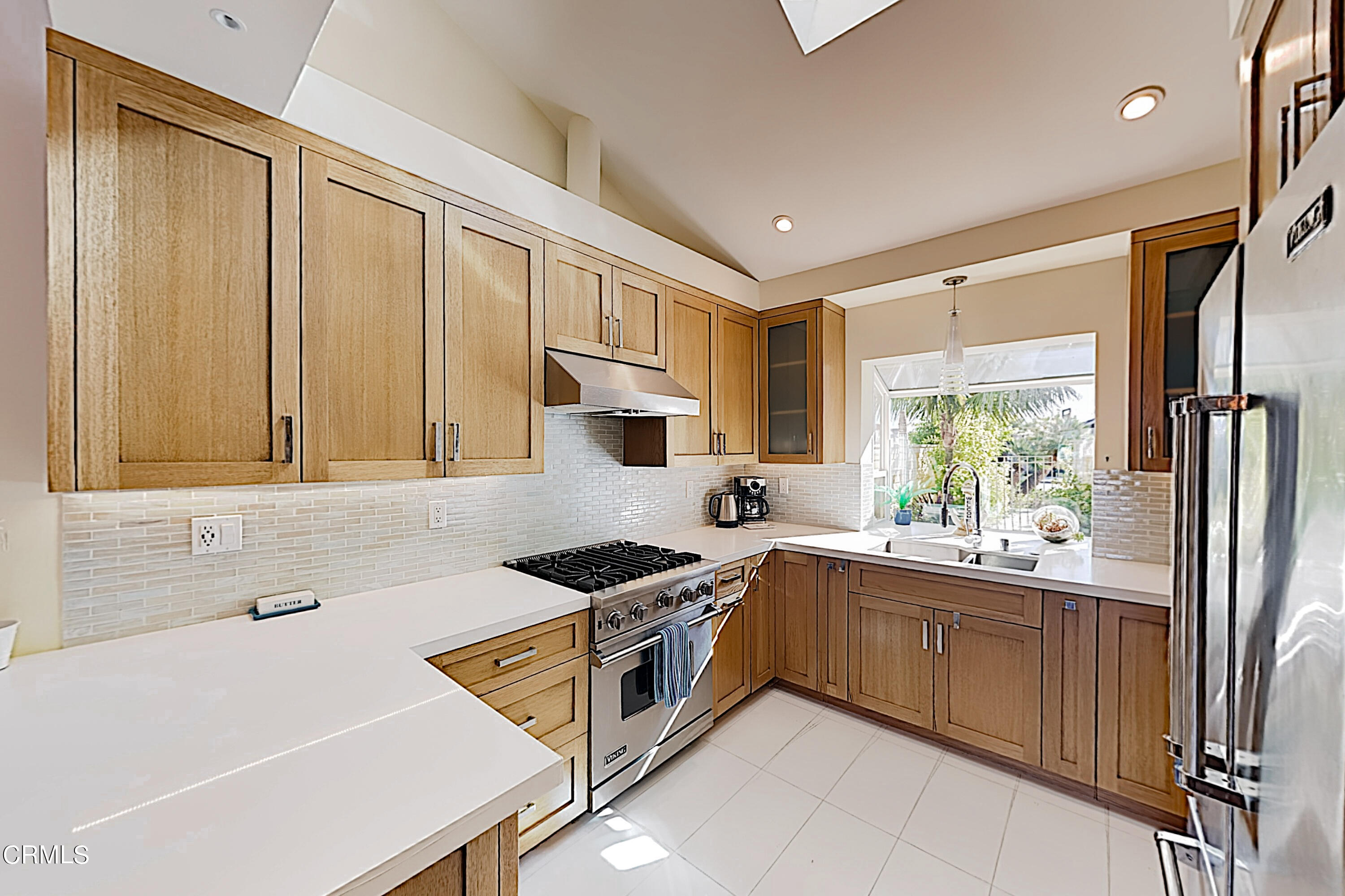 4531 Costa De Oro Oxnard, CA 93035 - Photo 23 of 26 a kitchen that has a sink a stove and a refrigerator