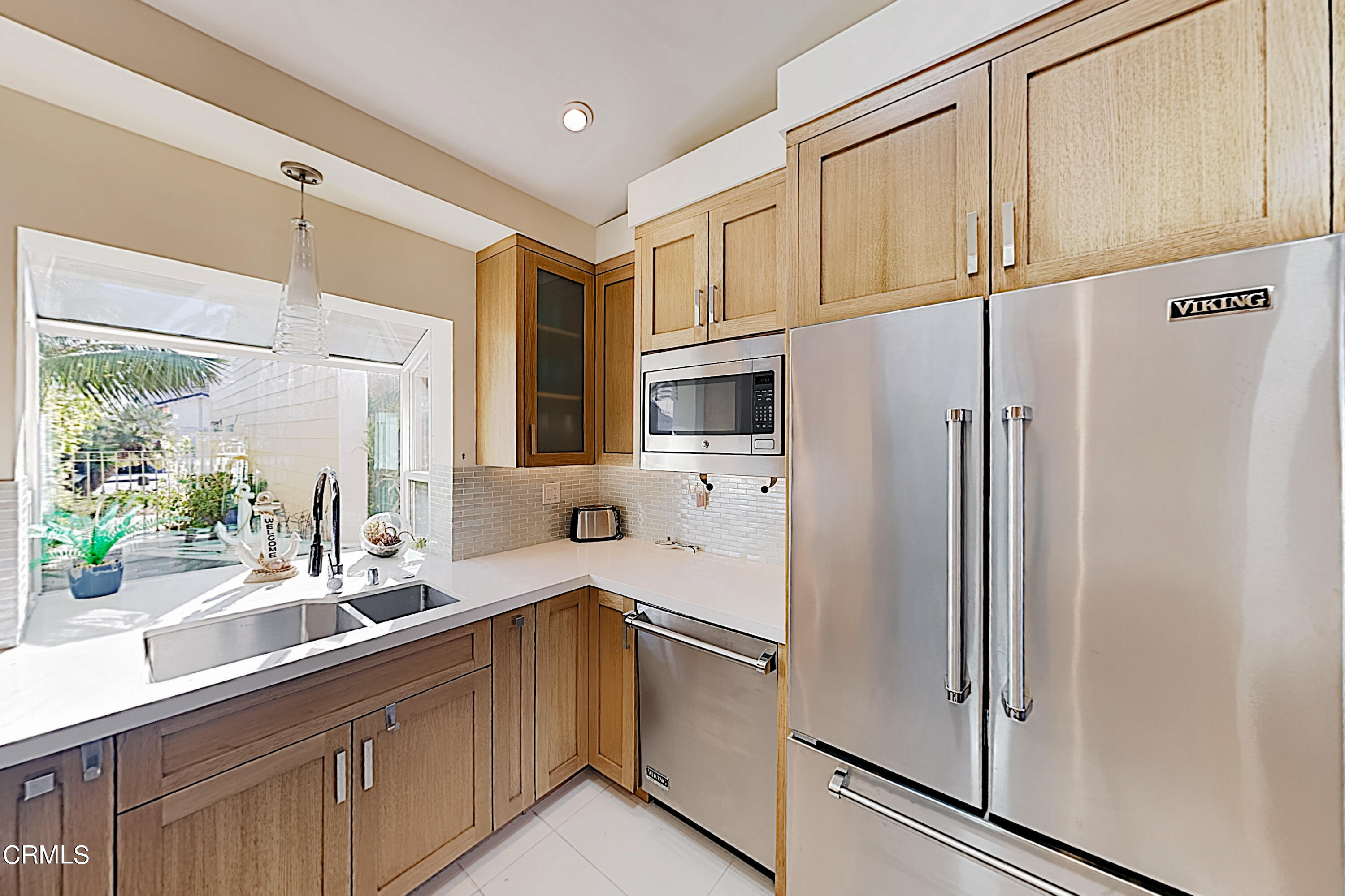 4531 Costa De Oro Oxnard, CA 93035 - Photo 3 of 26 a kitchen with stainless steel appliances a sink cabinets and a window