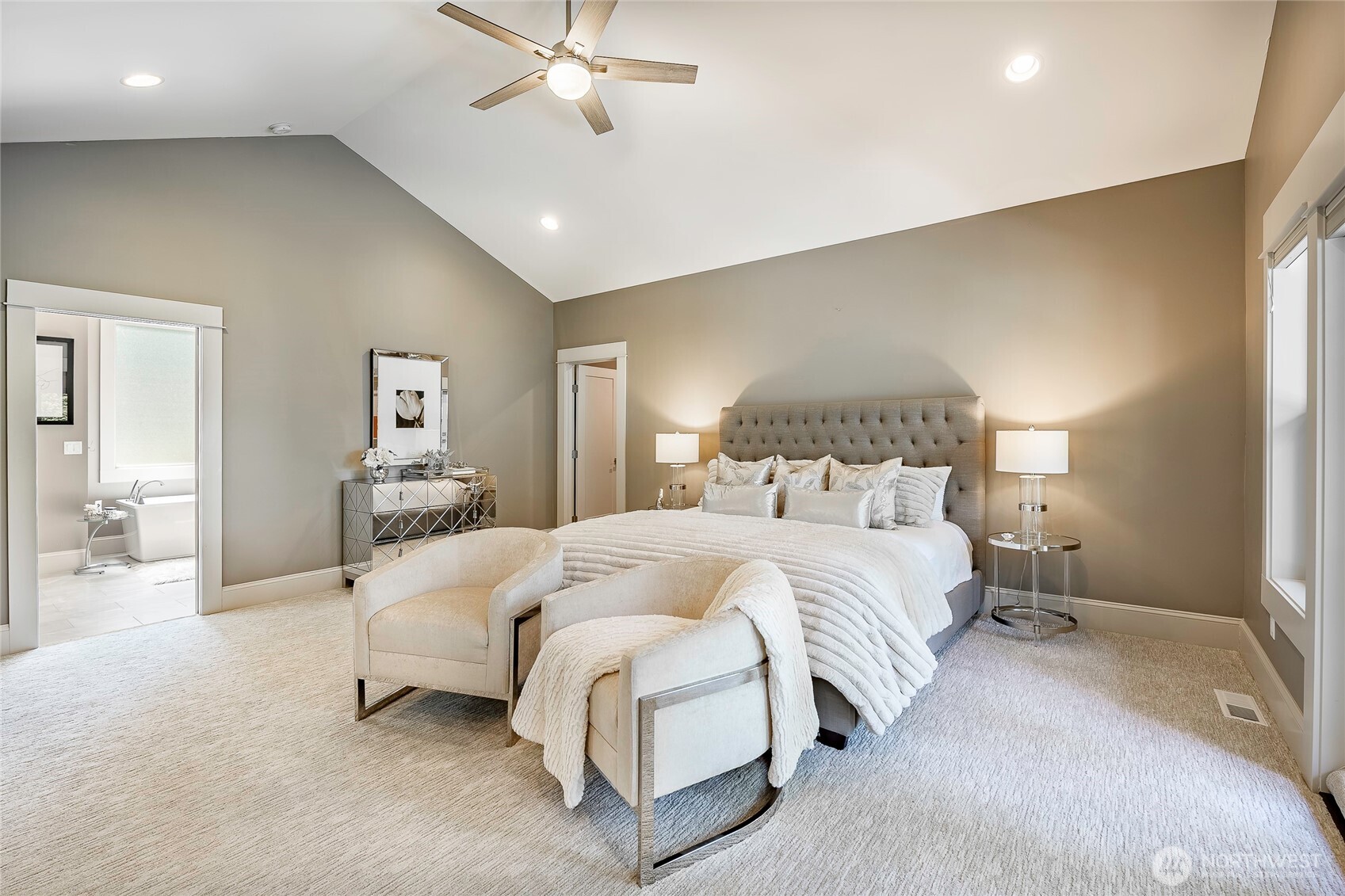 9125 Shearwater Road Blaine, WA 98230 - Photo 18 of 40 a spacious bedroom with a bed and a chandelier