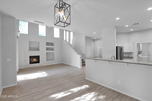 a view of a kitchen with wooden floor and a window