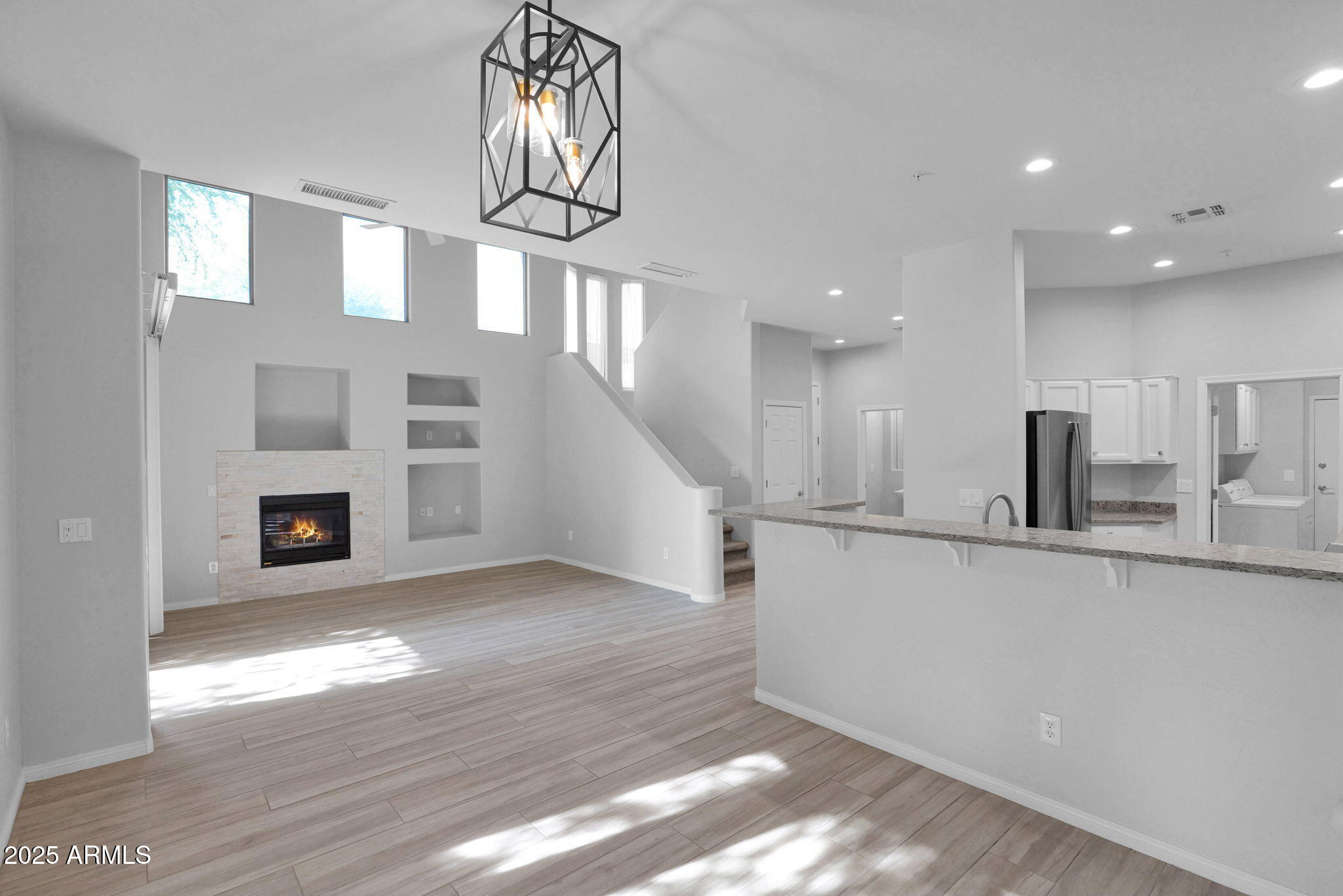 a view of a kitchen with wooden floor and a window