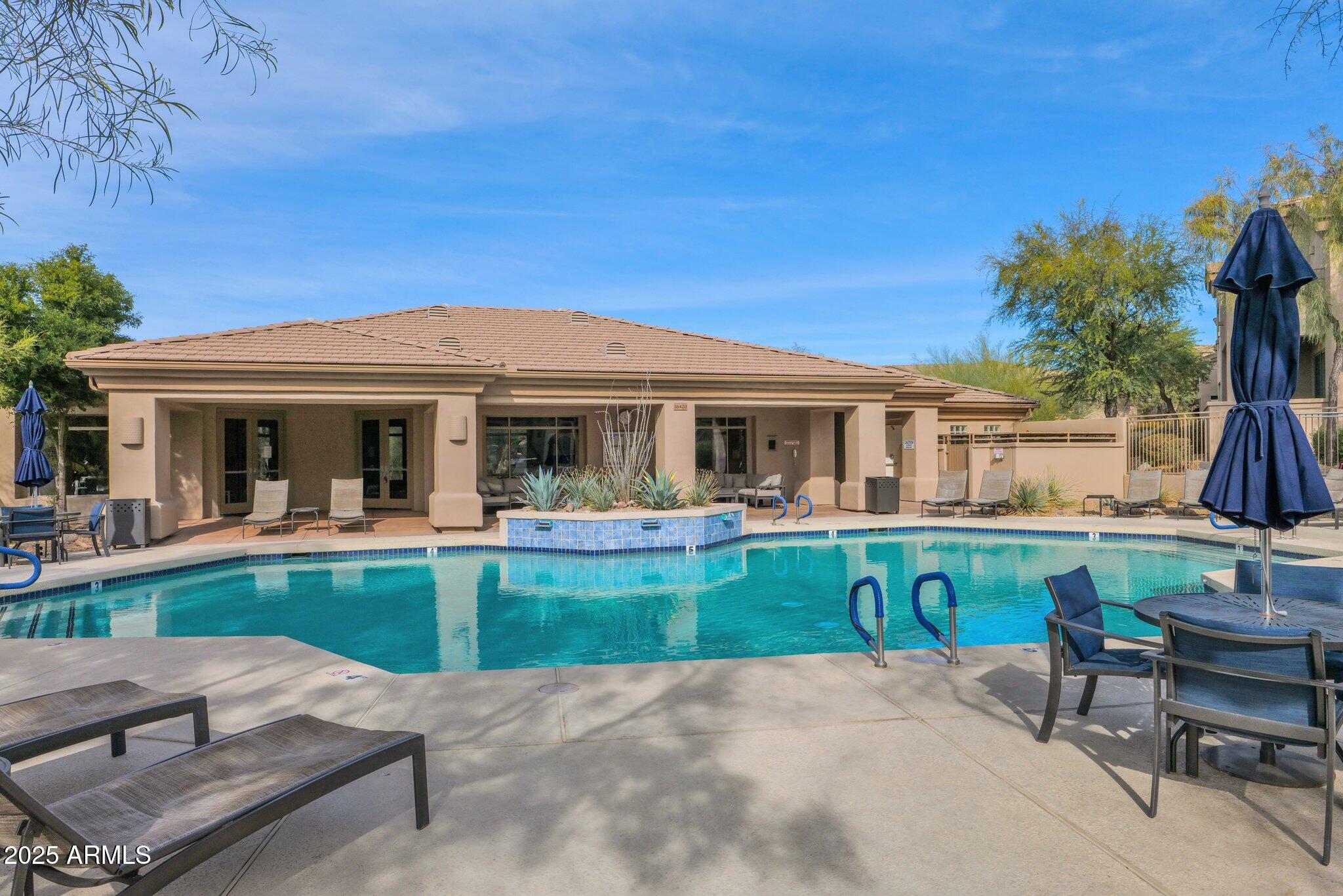16420 North Thompson Peak Parkway, Unit 1057 Scottsdale, AZ 85260 - Photo 26 of 39 a view of a house with a backyard and a patio