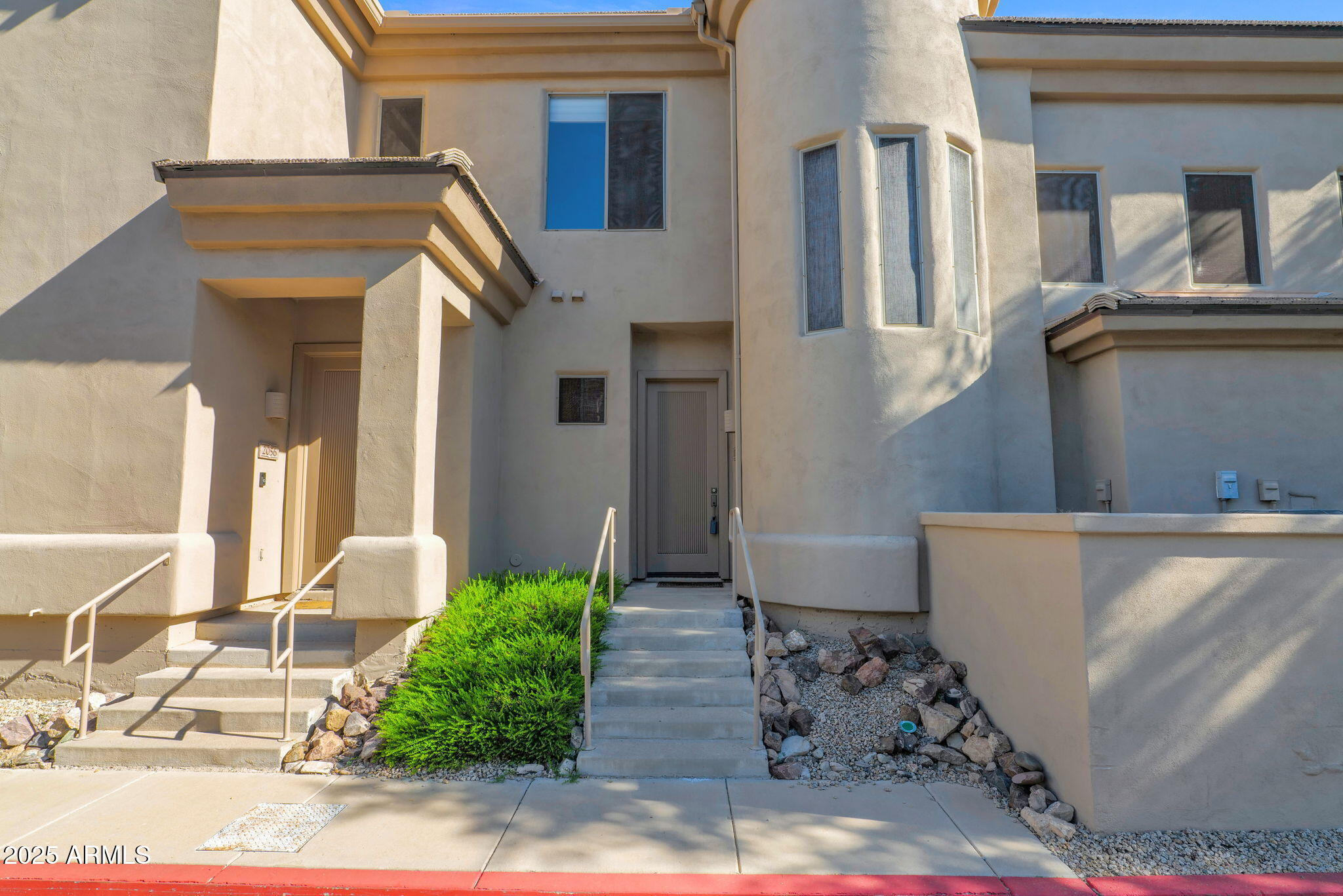 16420 North Thompson Peak Parkway, Unit 1057 Scottsdale, AZ 85260 - Photo 35 of 39 a front view of a house with garden