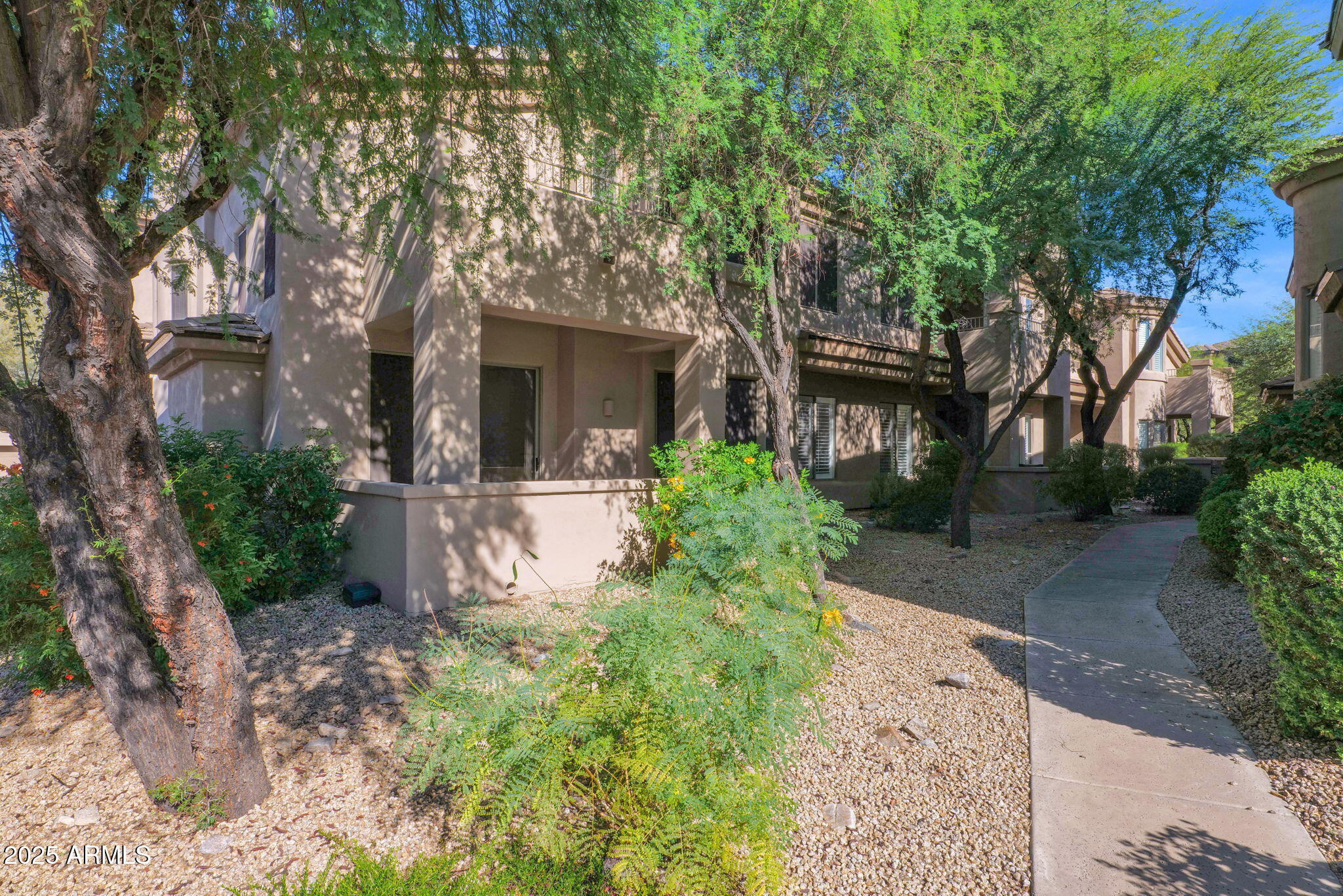 16420 North Thompson Peak Parkway, Unit 1057 Scottsdale, AZ 85260 - Photo 39 of 39 a front view of a house with garden