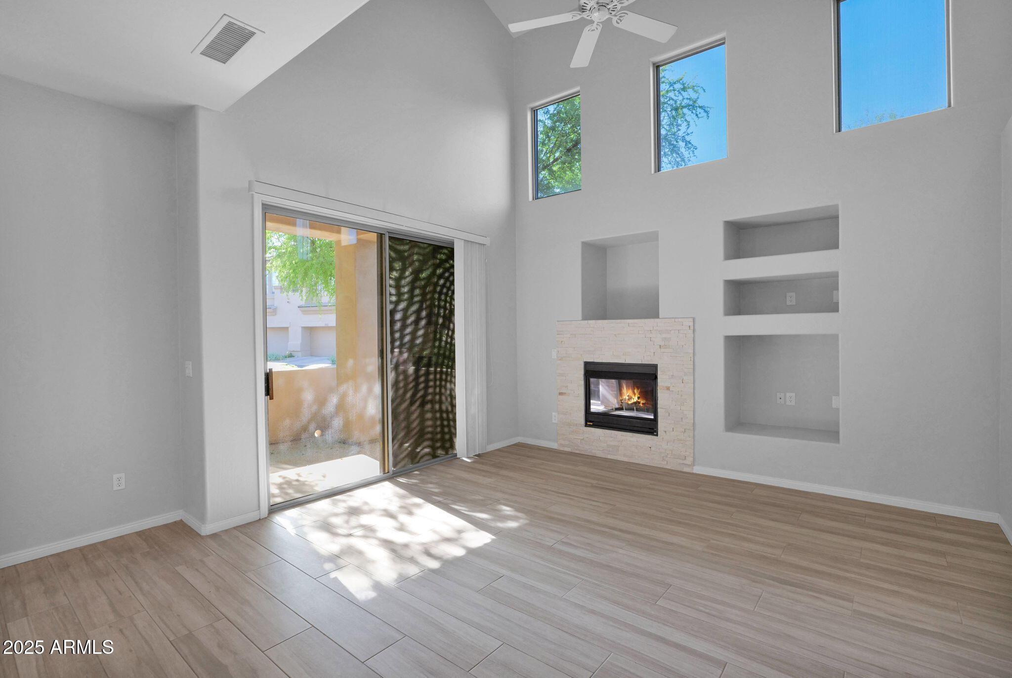 16420 North Thompson Peak Parkway, Unit 1057 Scottsdale, AZ 85260 - Photo 4 of 39 a view of an empty room with wooden floor and a window