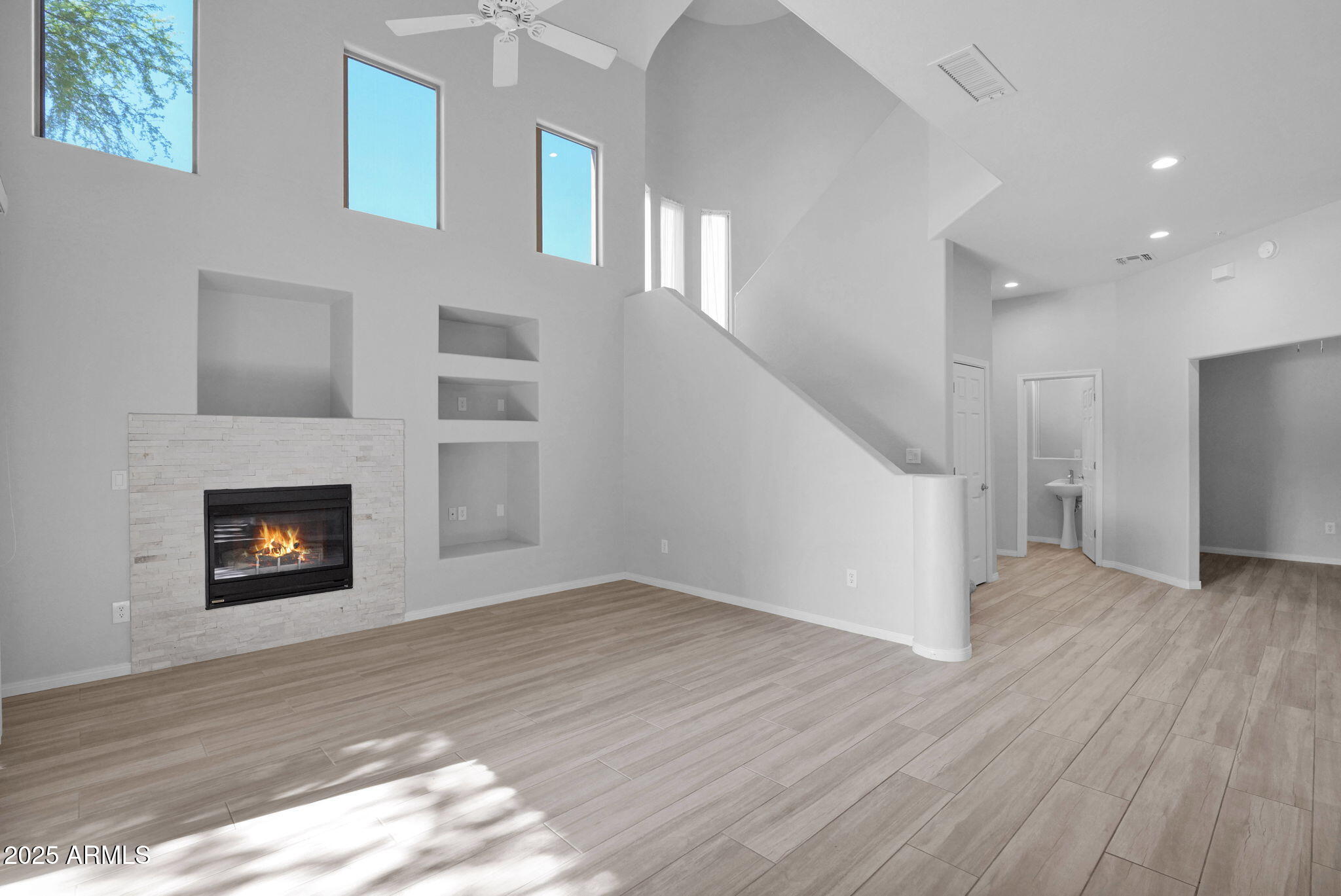 16420 North Thompson Peak Parkway, Unit 1057 Scottsdale, AZ 85260 - Photo 5 of 39 a view of an empty room with wooden floor and a fireplace