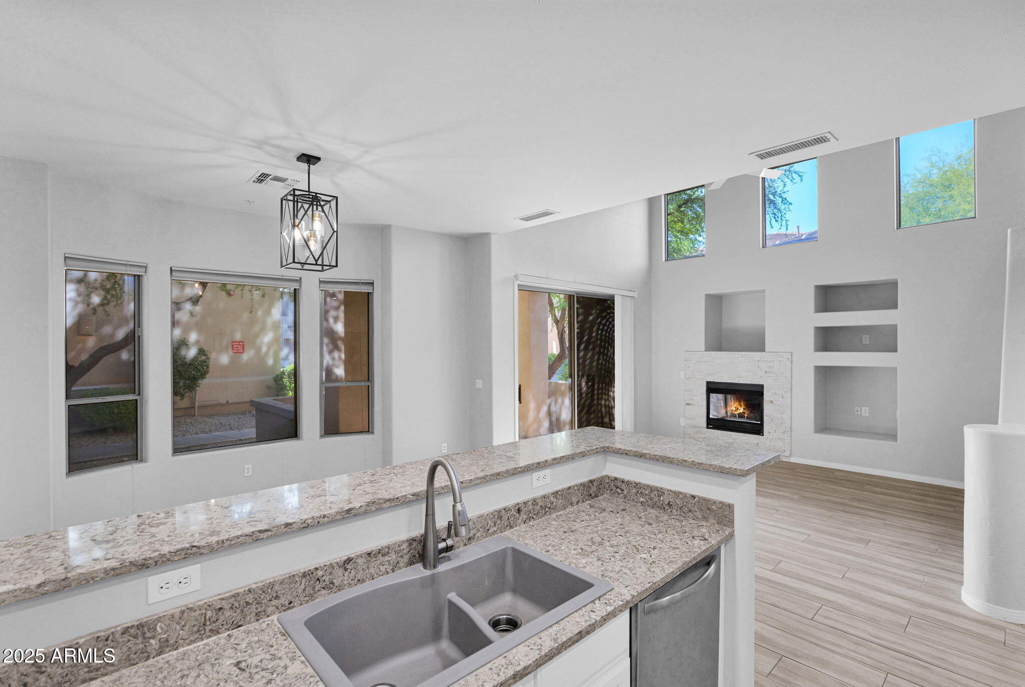 16420 North Thompson Peak Parkway, Unit 1057 Scottsdale, AZ 85260 - Photo 6 of 39 a view of an empty room with a kitchen and a window
