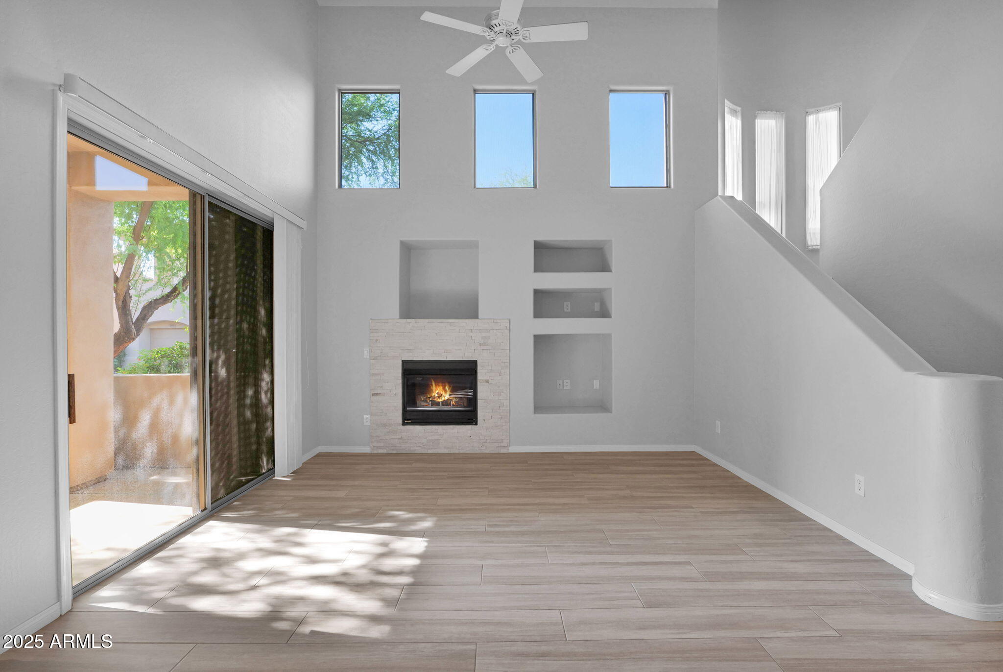 16420 North Thompson Peak Parkway, Unit 1057 Scottsdale, AZ 85260 - Photo 10 of 39 a view of empty room with a fireplace and a floor to ceiling window