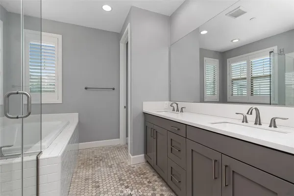 a bathroom with double vanity sink and a mirror