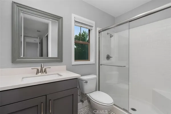 a bathroom with a sink a toilet and mirror