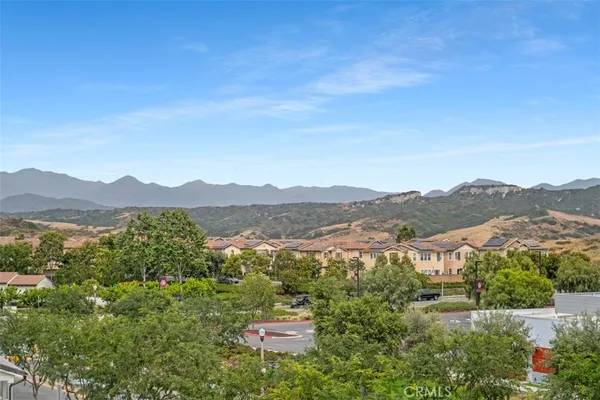an aerial view of residential houses with outdoor space and ocean view