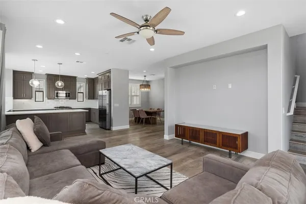a living room with furniture and kitchen view