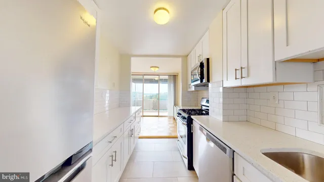 a kitchen with a sink and a refrigerator
