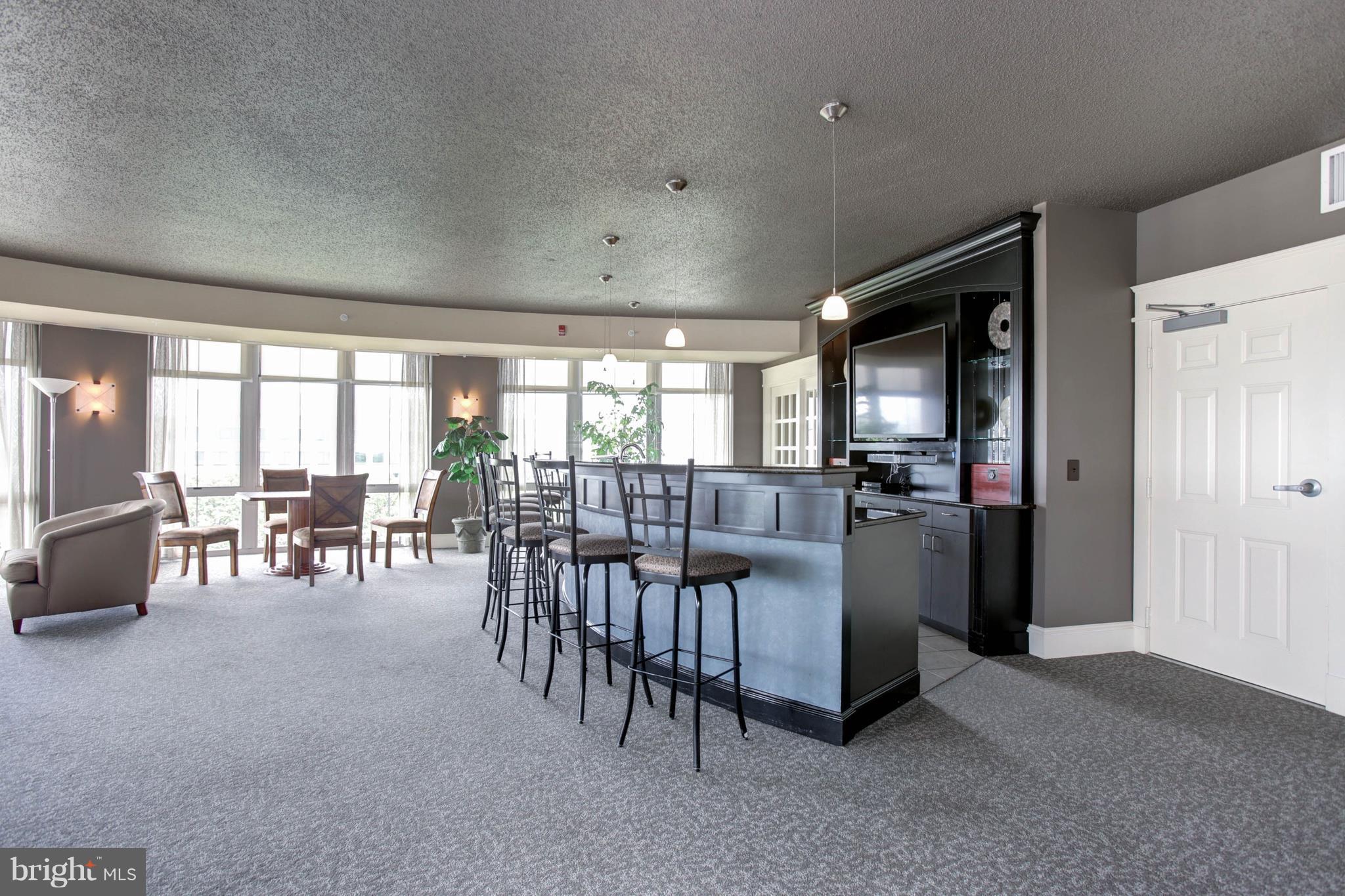 11800 Sunset Hills Road, Unit 314 Reston, VA 20190 - Photo 24 of 30 a living room with furniture and a table