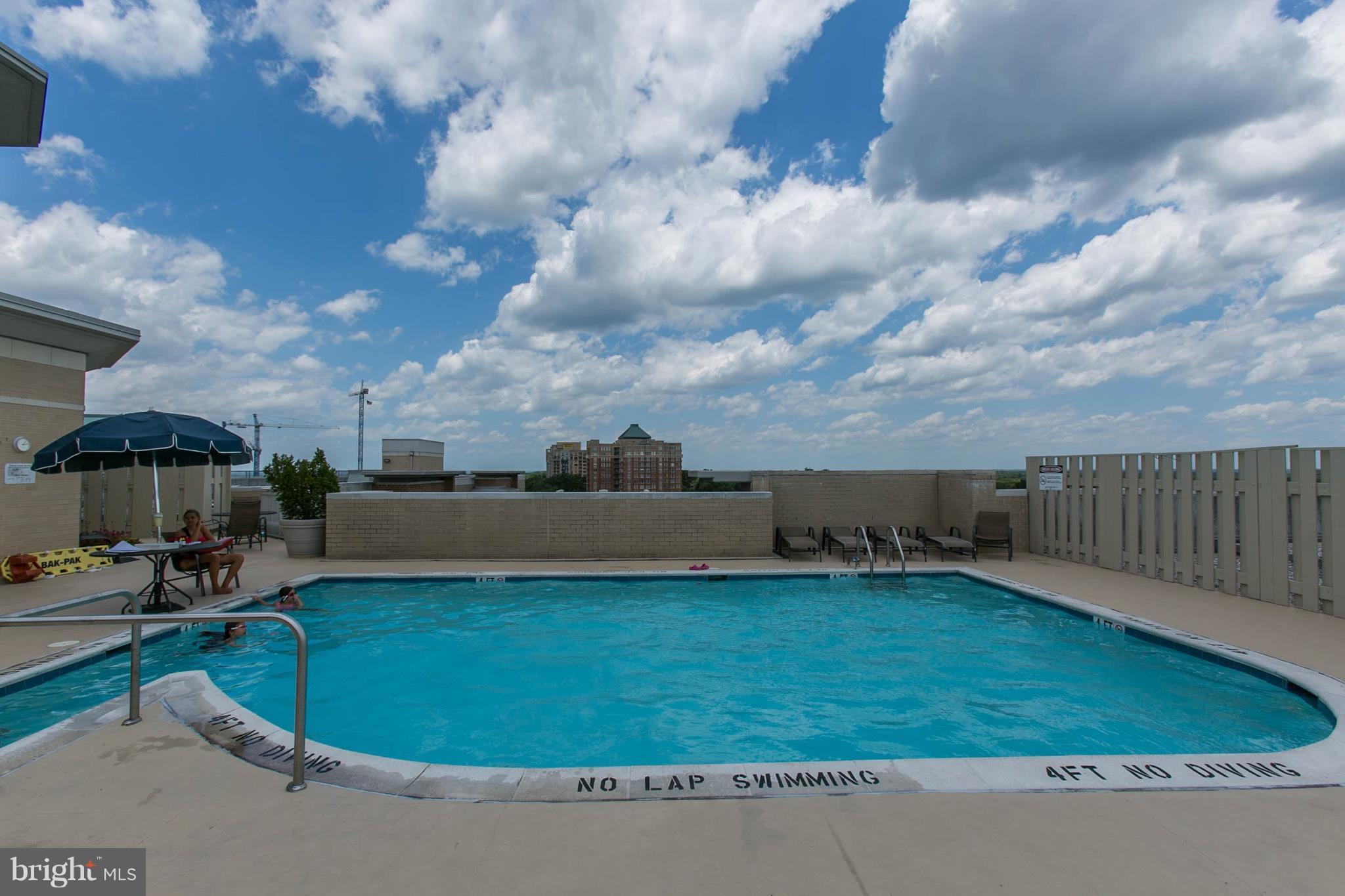 11800 Sunset Hills Road, Unit 314 Reston, VA 20190 - Photo 28 of 30 a view of a swimming pool and a yard