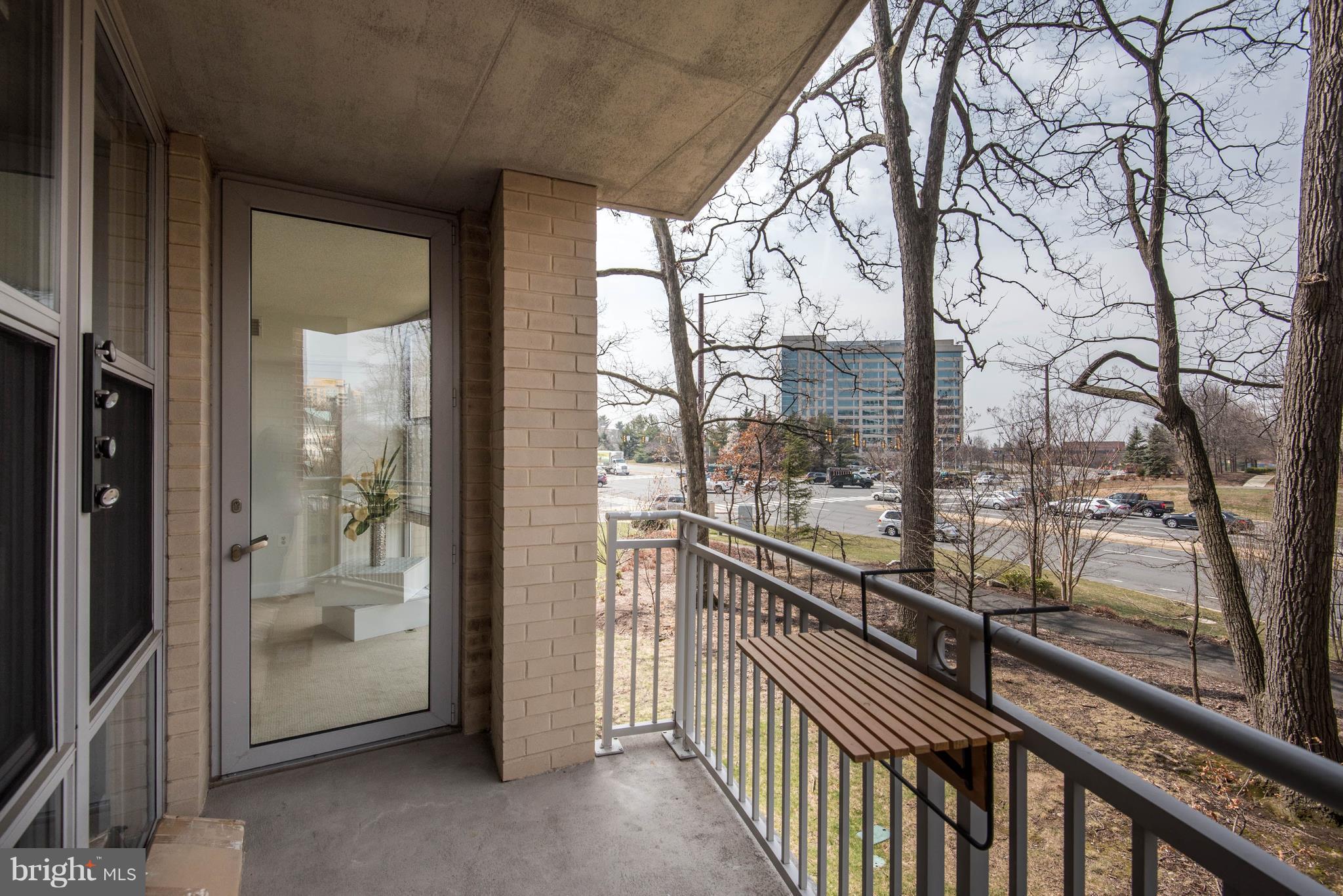 11800 Sunset Hills Road, Unit 314 Reston, VA 20190 - Photo 36 of 53 a view of a glass door with a trees from a glass door