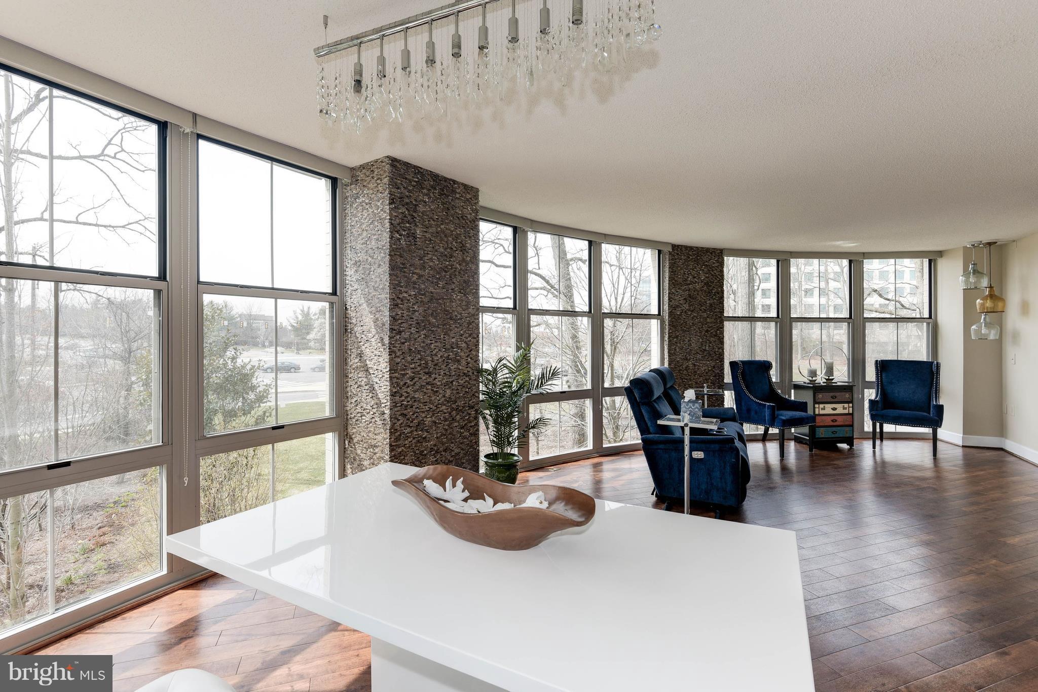 11800 Sunset Hills Road, Unit 314 Reston, VA 20190 - Photo 4 of 30 a living room with furniture and a large window