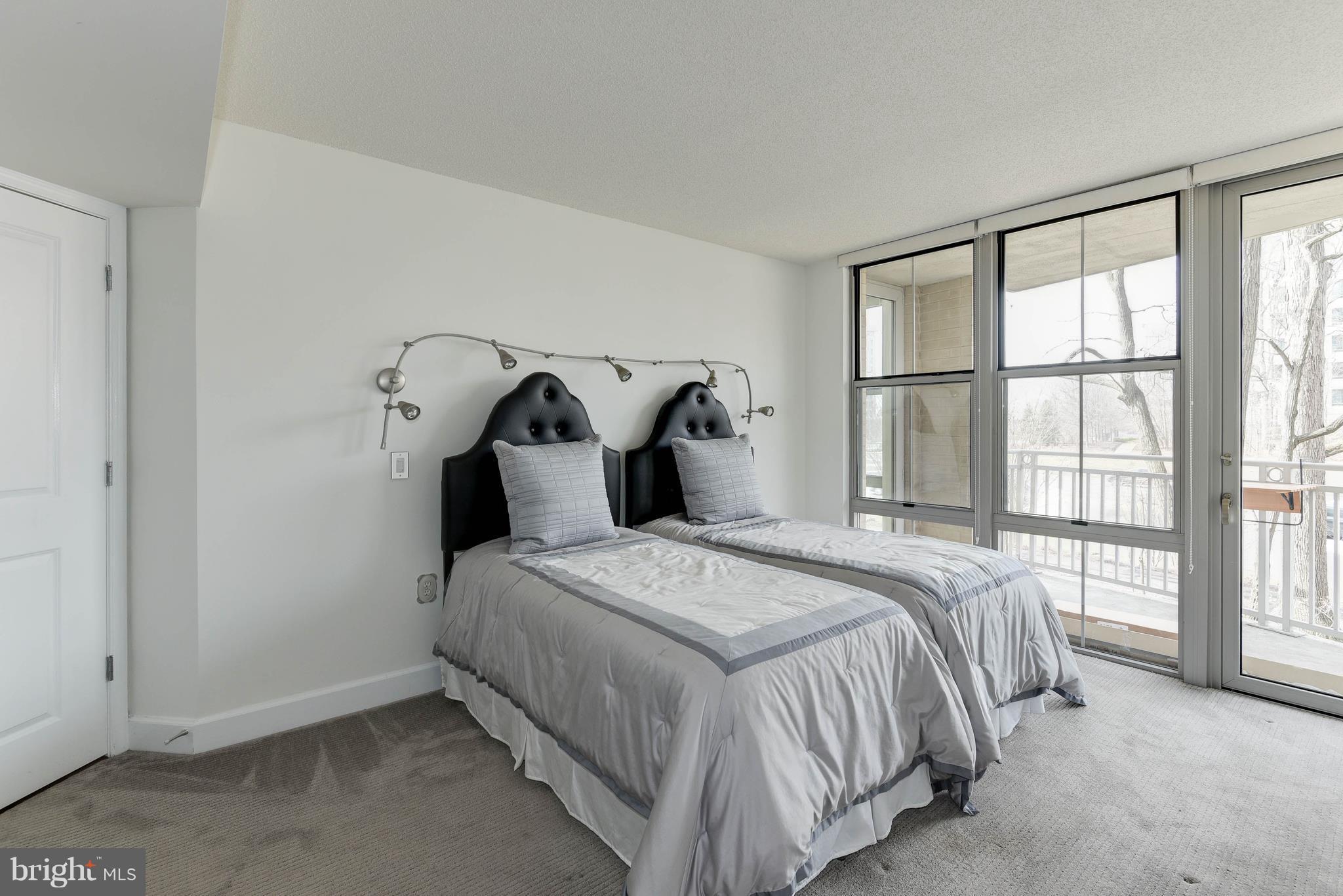 11800 Sunset Hills Road, Unit 314 Reston, VA 20190 - Photo 45 of 53 a bedroom with a bed and large windows