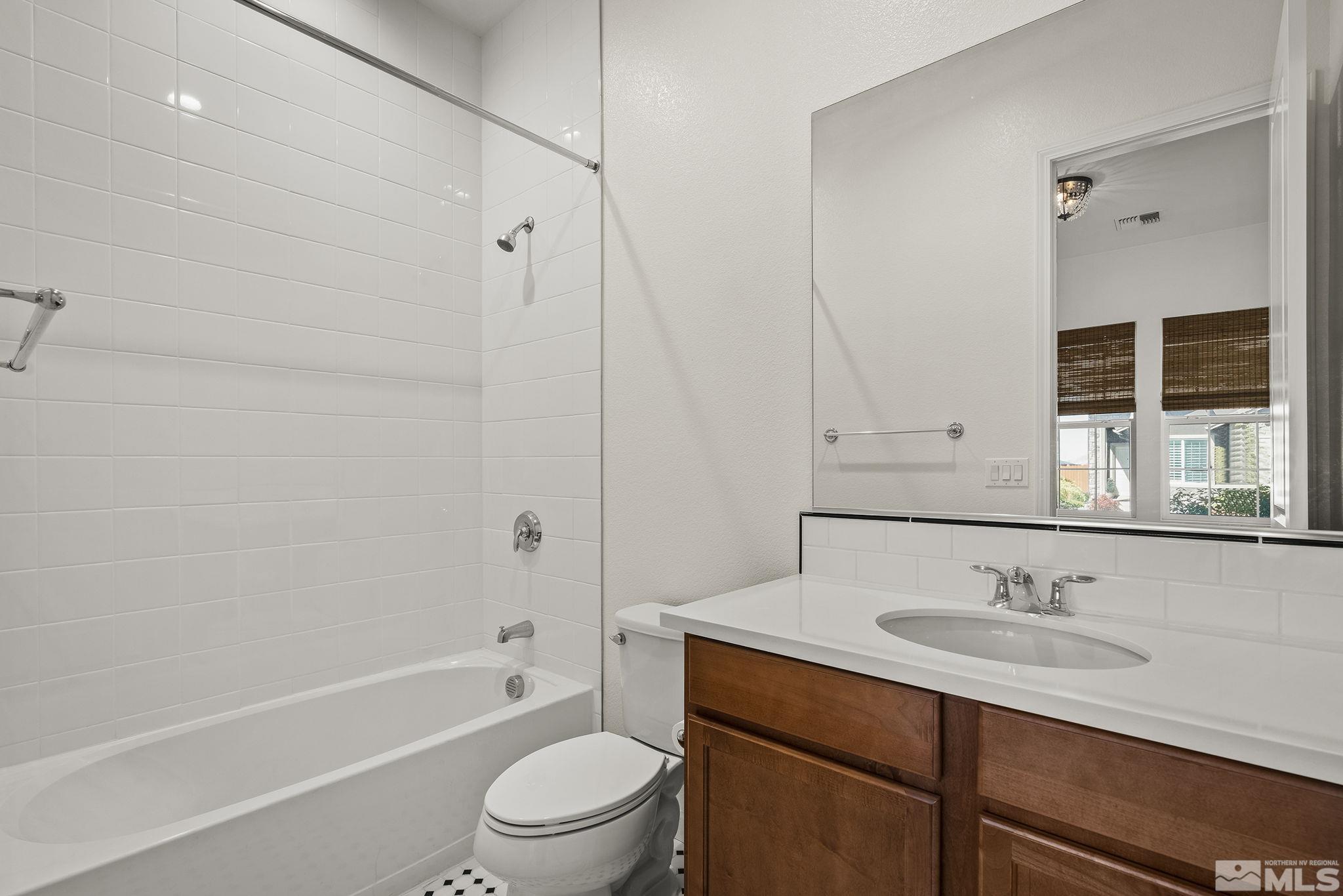 2460 Buttermere Court Reno, NV 89521 - Photo 17 of 22 a bathroom with a granite countertop sink a toilet and shower