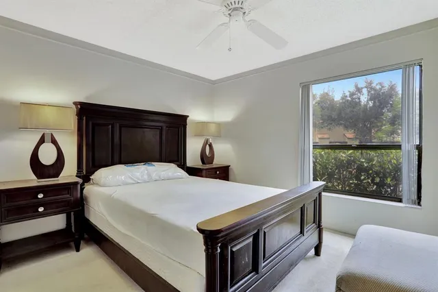 a bedroom with a bed and a large window