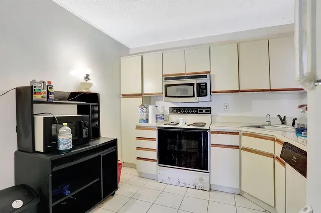 a kitchen with cabinets and steel appliances
