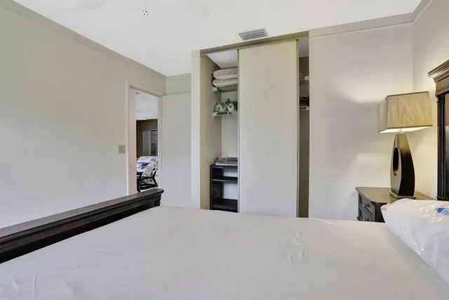 a bedroom with a bed and a mirror