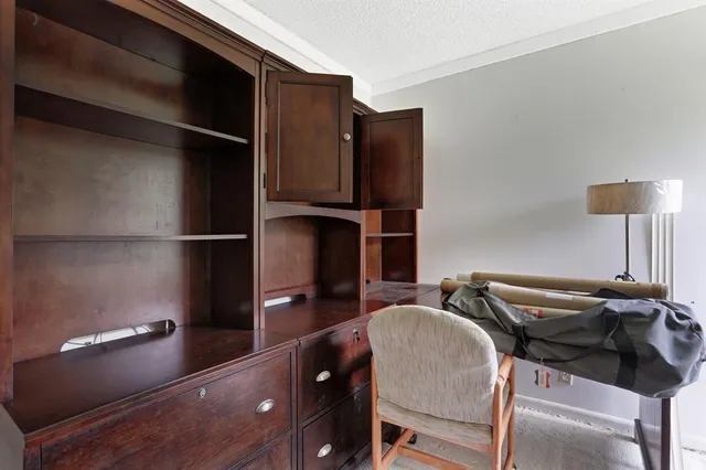 a kitchen with a refrigerator and a chair