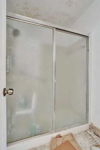 a bathroom with a glass shower door