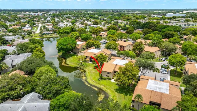 an aerial view of residential houses with outdoor space and trees