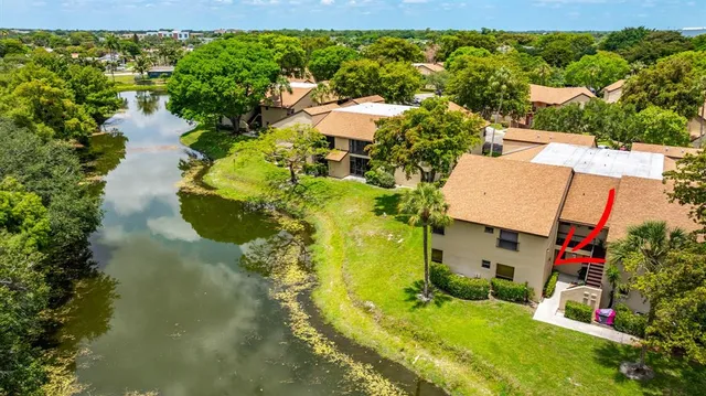 an aerial view of a house with a yard basket ball court and outdoor seating