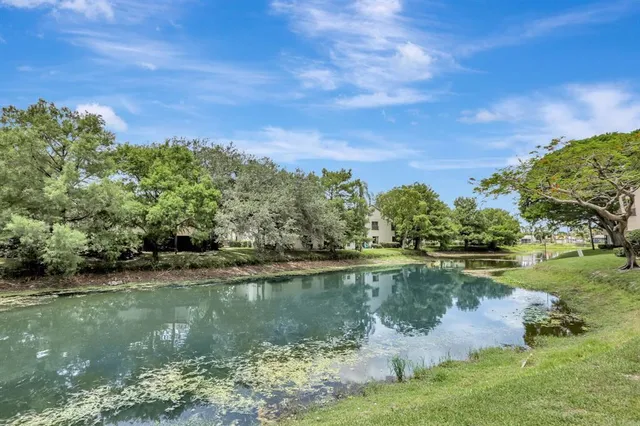 a view of a lake with houses in the back