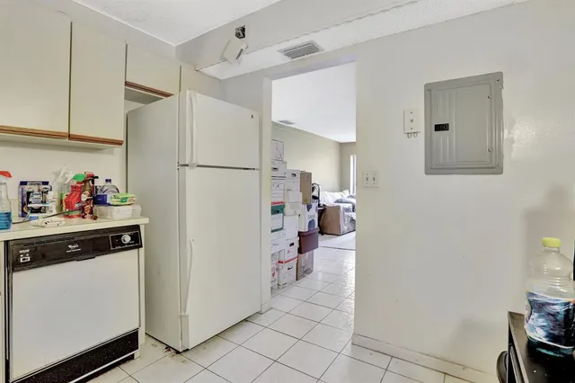 a kitchen with a refrigerator and cabinets