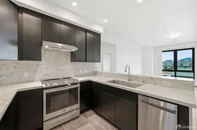 a kitchen with a refrigerator and a sink
