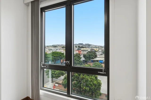 a bedroom with a large bed and a potted plant