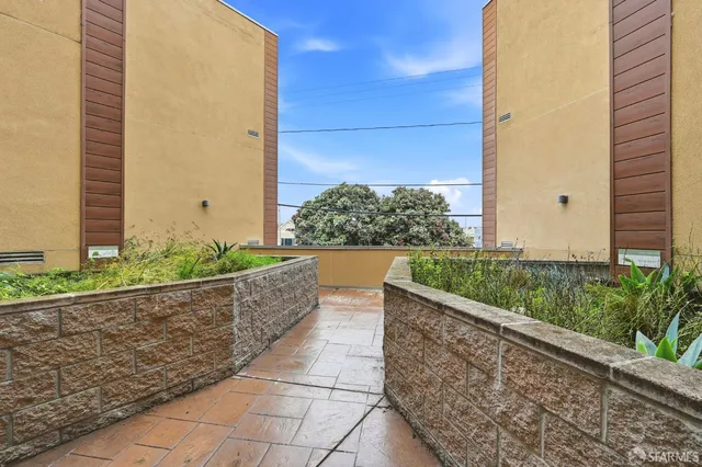 a view of a building with backyard and sitting area