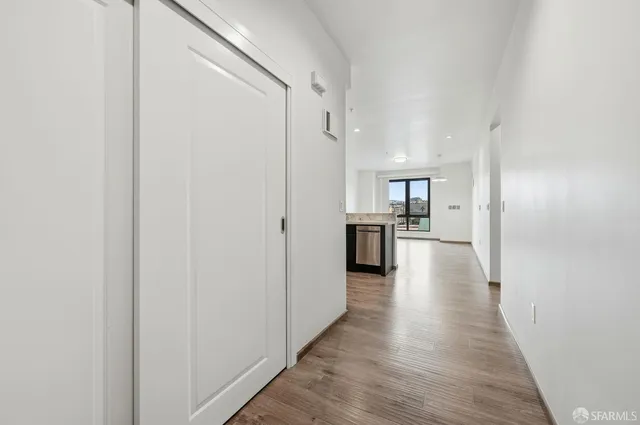 an empty room with wooden floor and a window