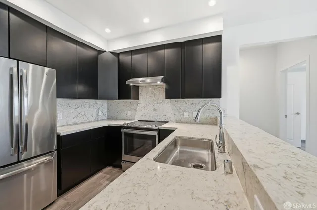 a kitchen with a sink and a stove