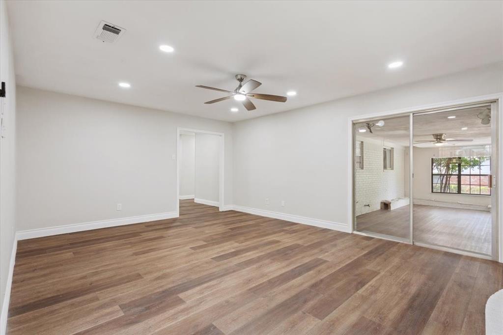 849 Arlington Drive Woodway, TX 76712 - Photo 14 of 33 wooden floor in an empty room with a window